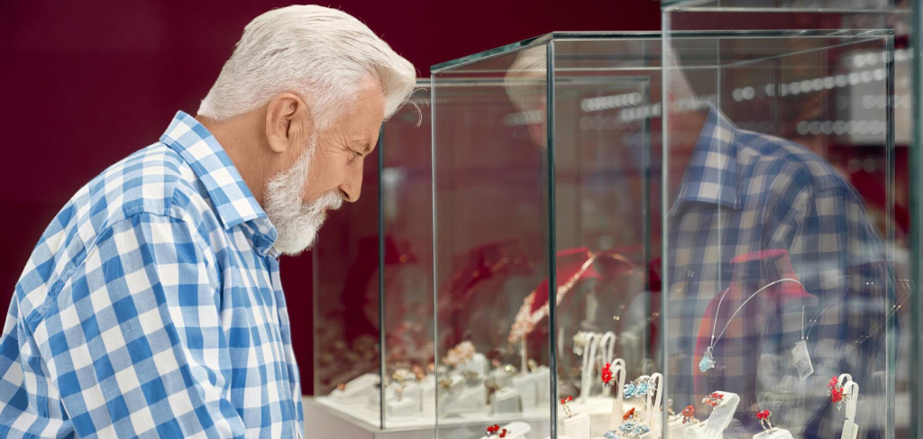 side-view-senior-man-standing-near-showcase-with-jewerly_651396-1483.jpg